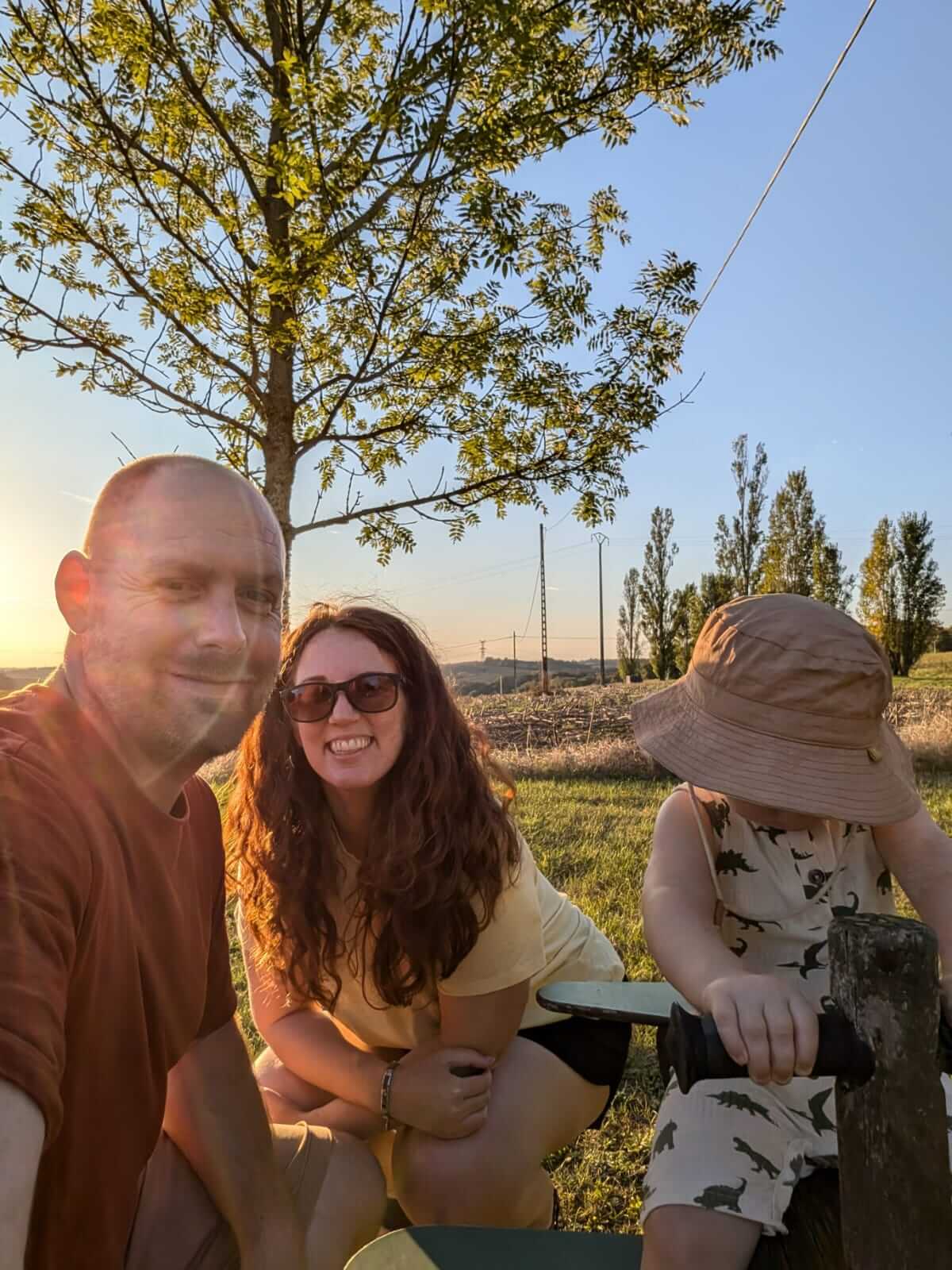 Young family enjoying sunset in woodland in France, capturing slow travel and quality time together