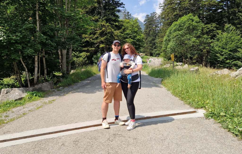 The author with her partner and child during a family trip, all smiling together in a natural setting, radiating joy and adventure.