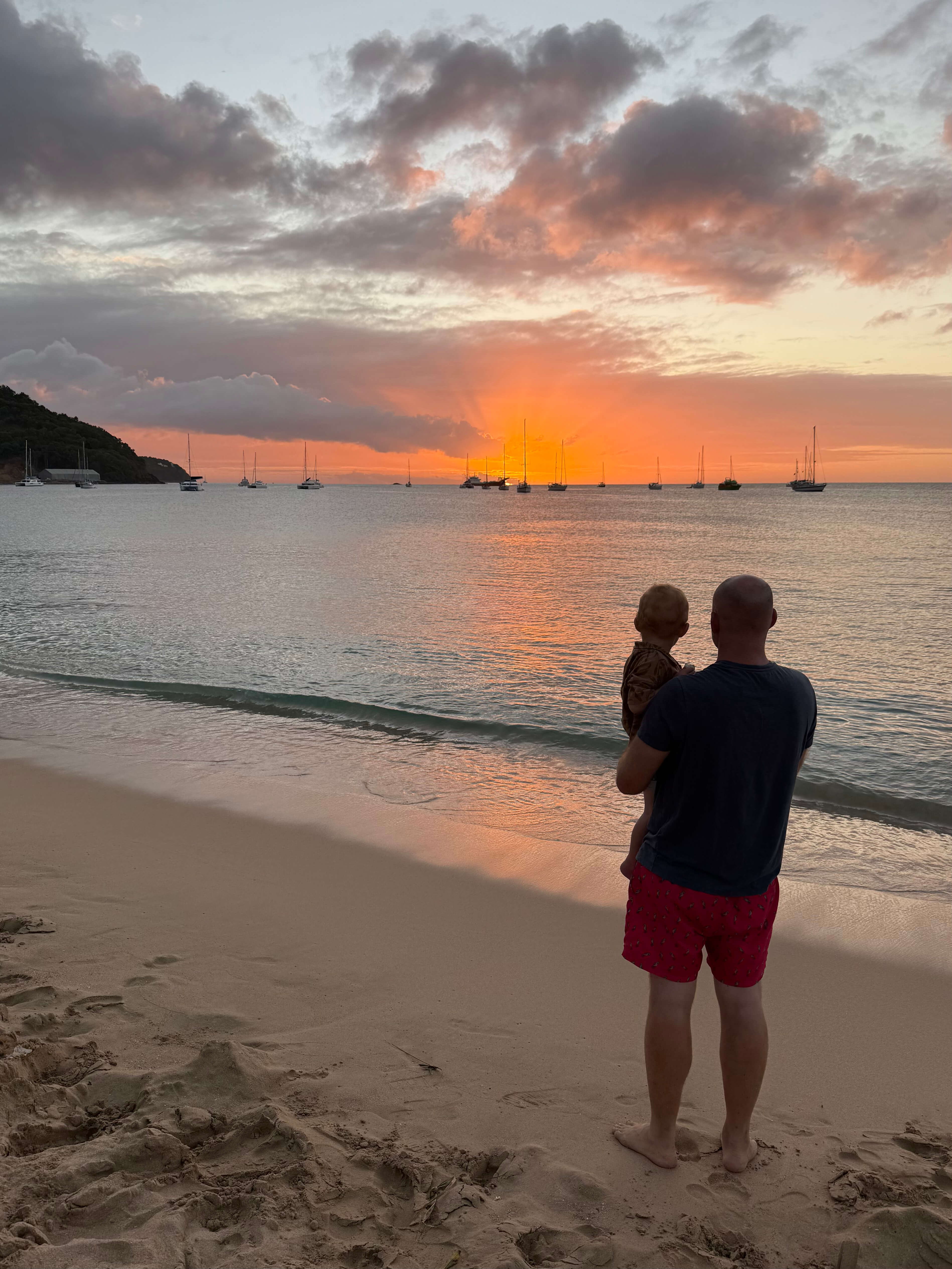 Father and son watching the sunset, a quiet moment from our family journey on the road