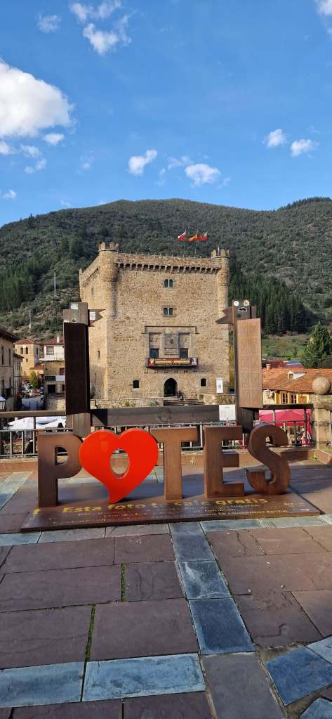 Cobbled streets and red-roofed buildings in the charming mountain town of Potes, Spain.