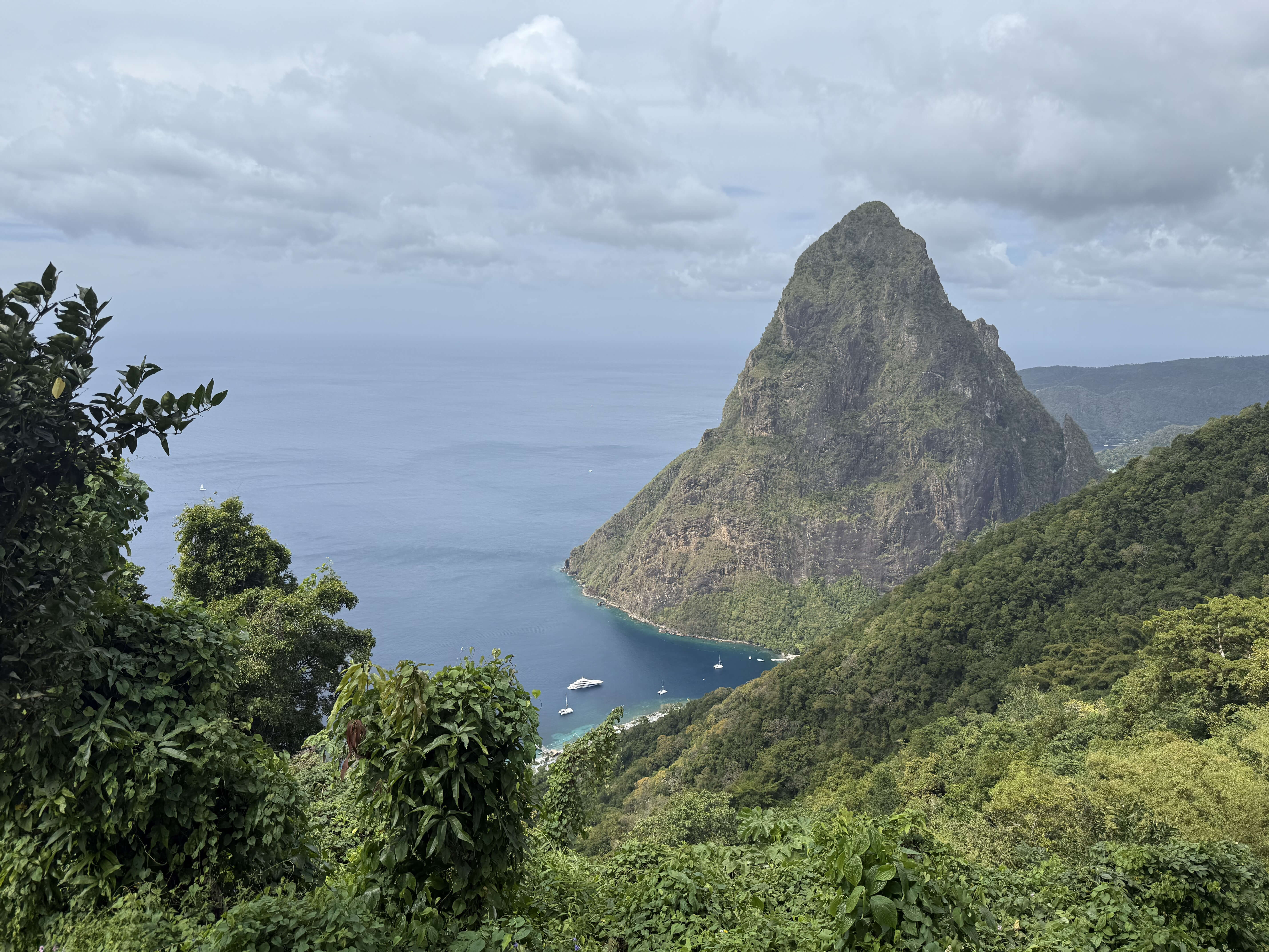 Family-friendly beach scene in Saint Lucia with the Pitons in the background, capturing the spirit of slow, scenic Caribbean travel