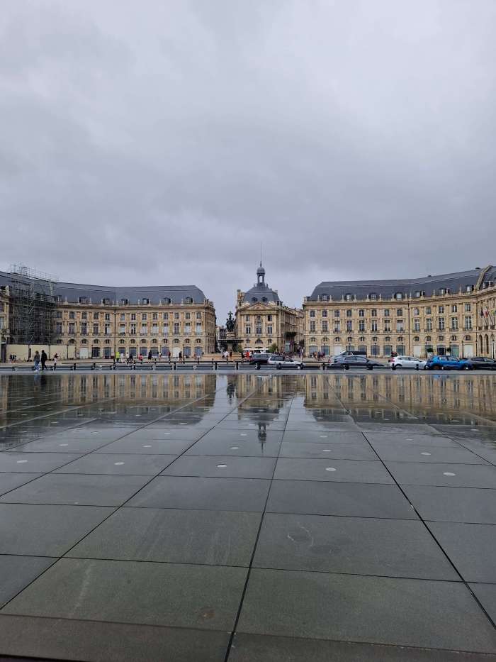 Rain-soaked reflections at Bordeaux’s Miroir d’eau – because van life doesn’t come with a weather guarantee