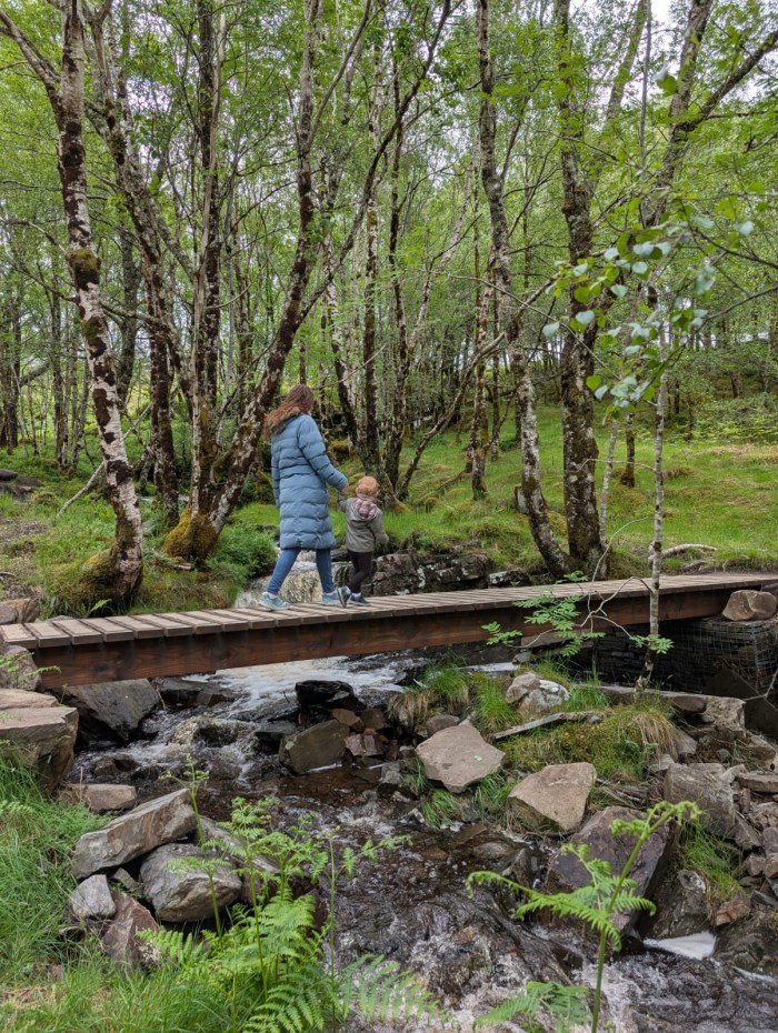 Walking across a foot bridge at Corrieshalloch Gorge on the NC500