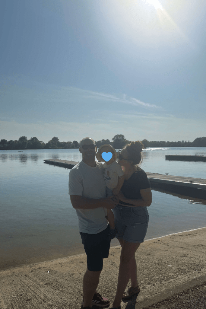 Family by a lake at sunset, peaceful van life moment
