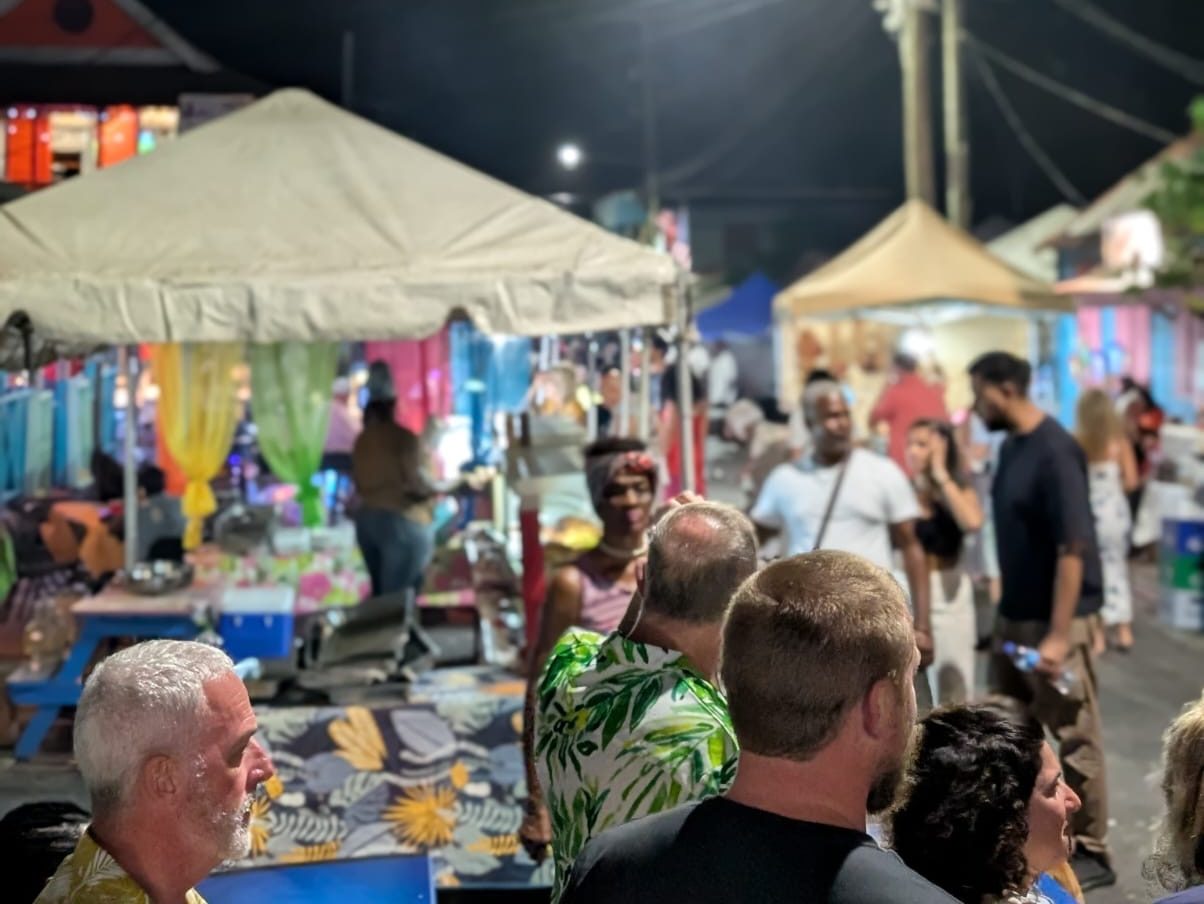 Crowd of people enjoying the Gros Islet Friday Night Street Party with music and lights