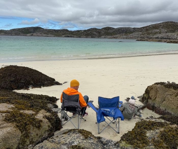 Simple beach setup during our NC500 campervan trip Two camping chairs facing the sea on a remote Scottish beach