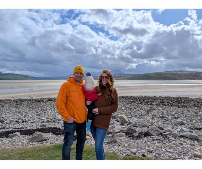 Family standing at a scenic viewpoint in Scotland