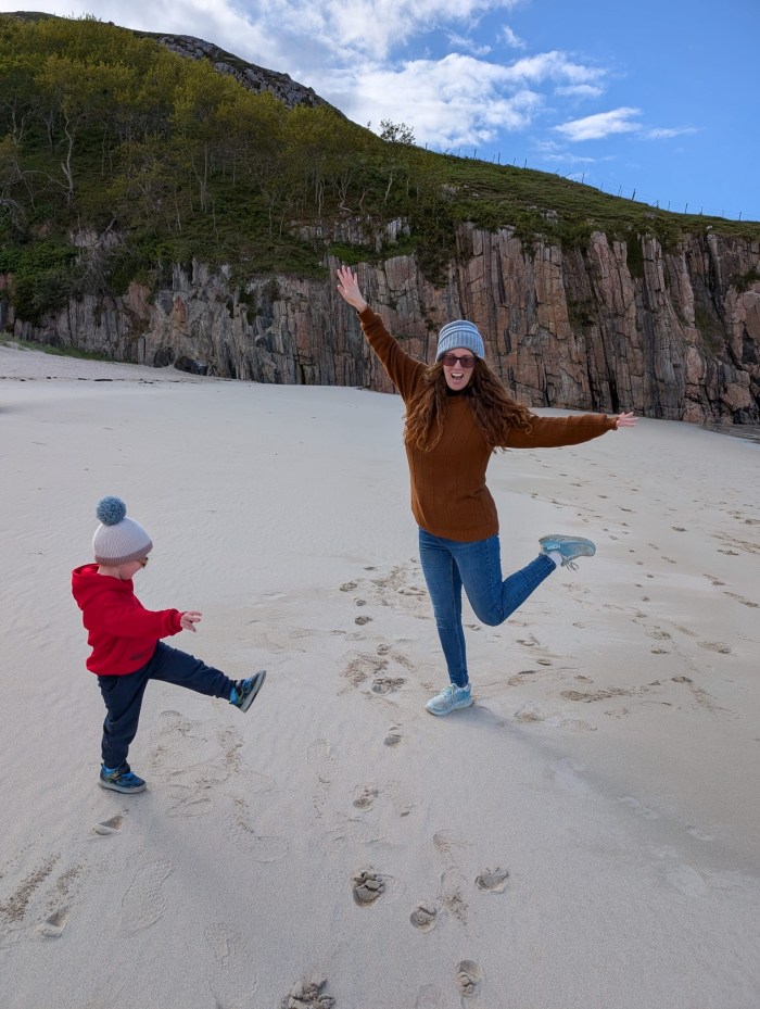 Woman playing with toddler on a Scottish beach
