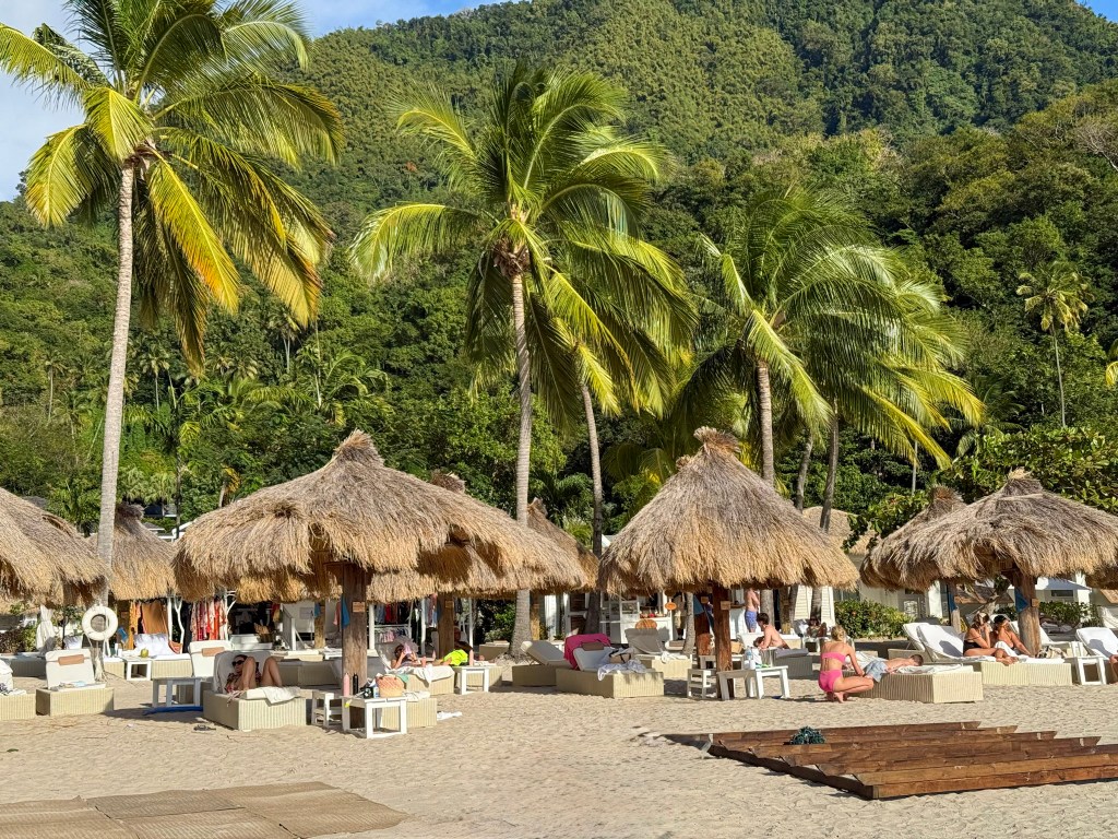 Sugar Beach, Saint Lucia from the sea View of Sugar Beach in Saint Lucia with palm trees, sunbeds and white sand, seen from the Caribbean Sea